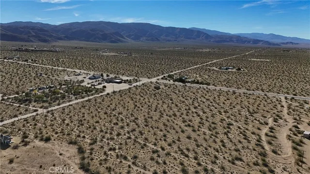 a view of a large mountain with a mountain in the background