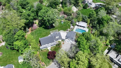 an aerial view of a house with outdoor space and street view