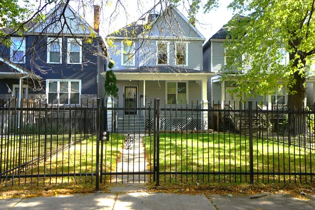 a front view of a house with a iron fence