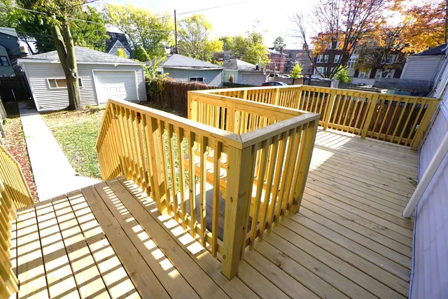a view of balcony with wooden floor and fence