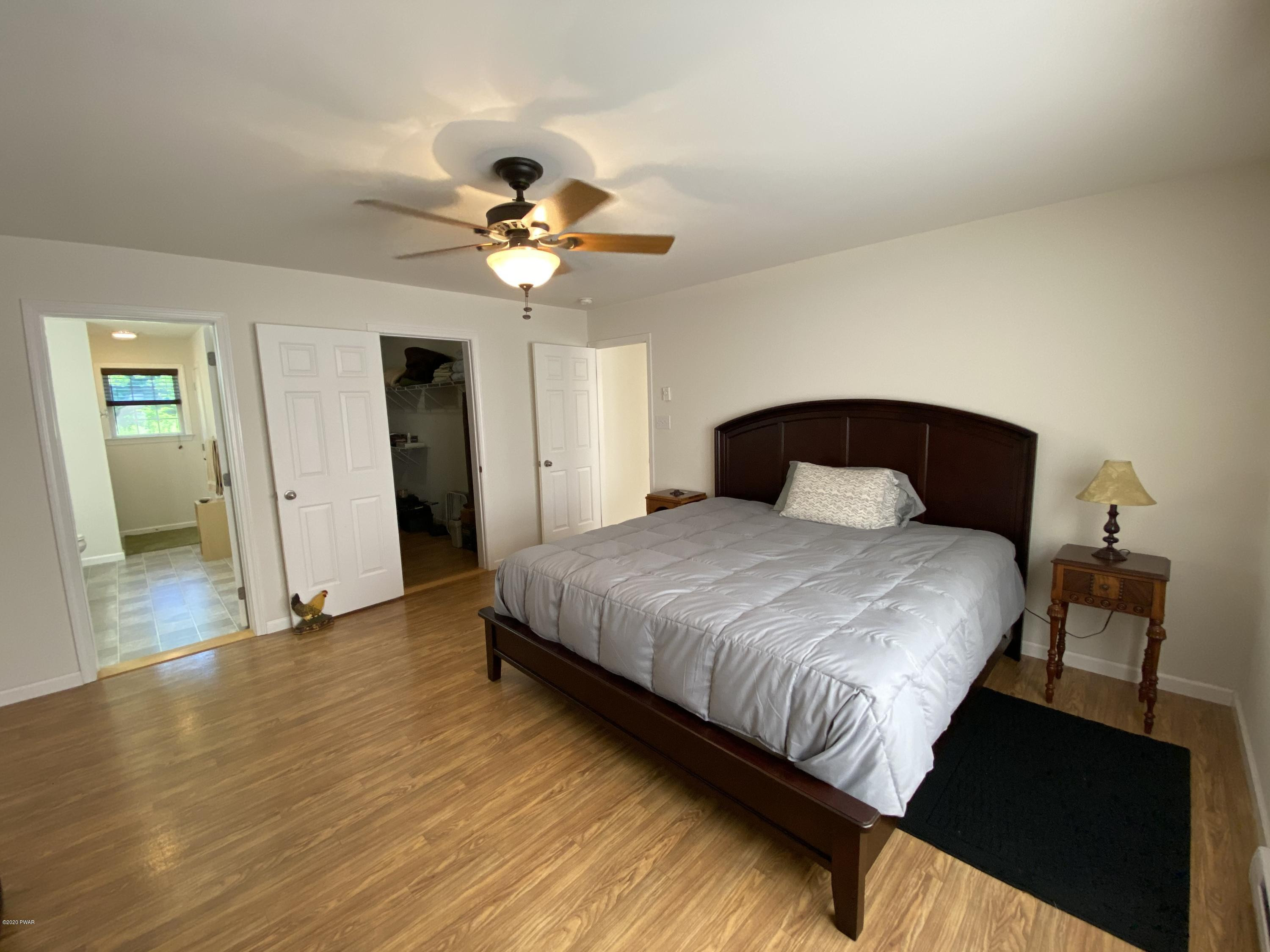 283 Mill Brook Road Waymart, PA 18472 - Photo 8 of 30 a bedroom with a bed and wooden floor