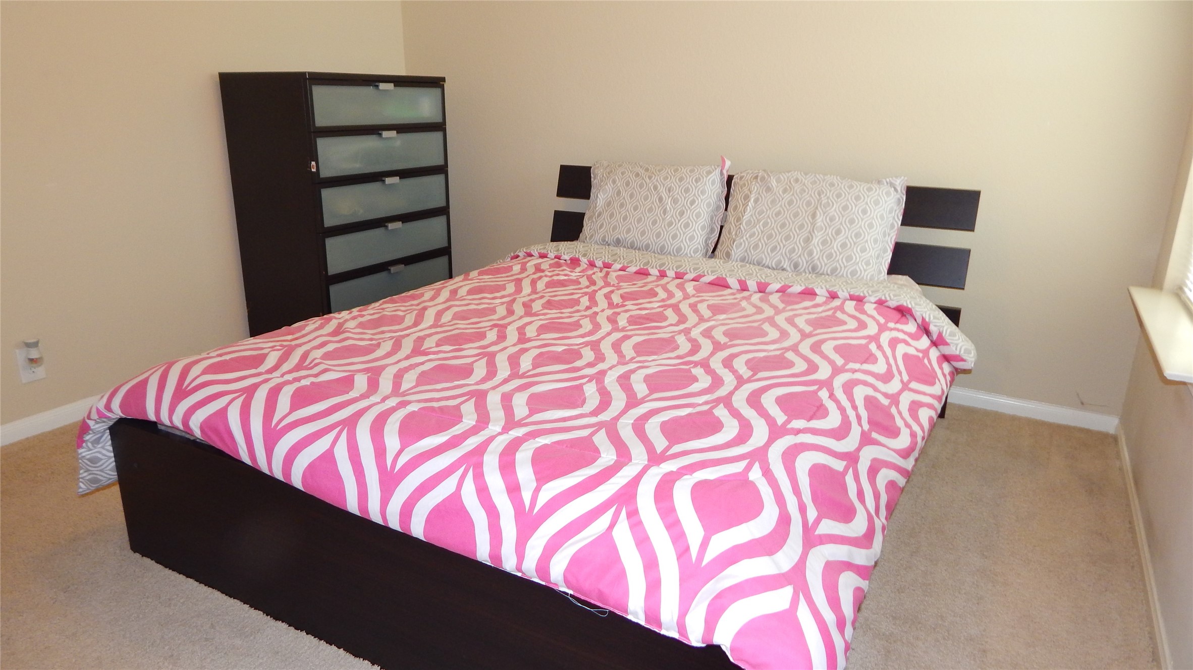 3219 Creole Bay Lane Rosenberg, TX 77471 - Photo 18 of 35 a bed sitting in a bedroom next to a cabinet