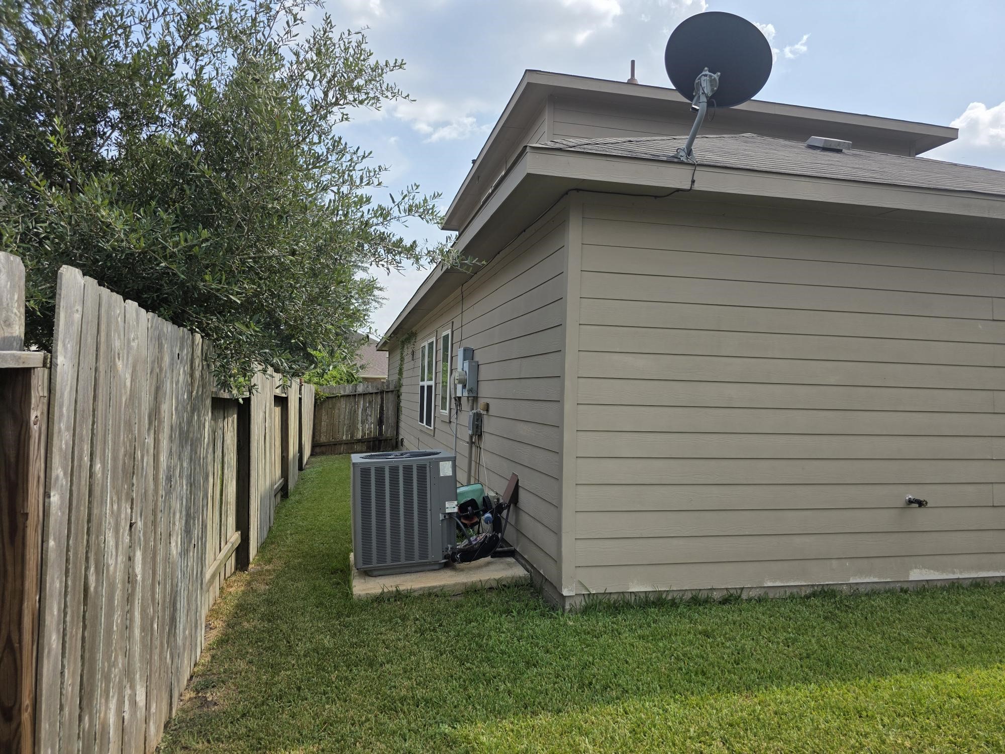 3219 Creole Bay Lane Rosenberg, TX 77471 - Photo 29 of 35 a view of a backyard with a small cabin and wooden fence