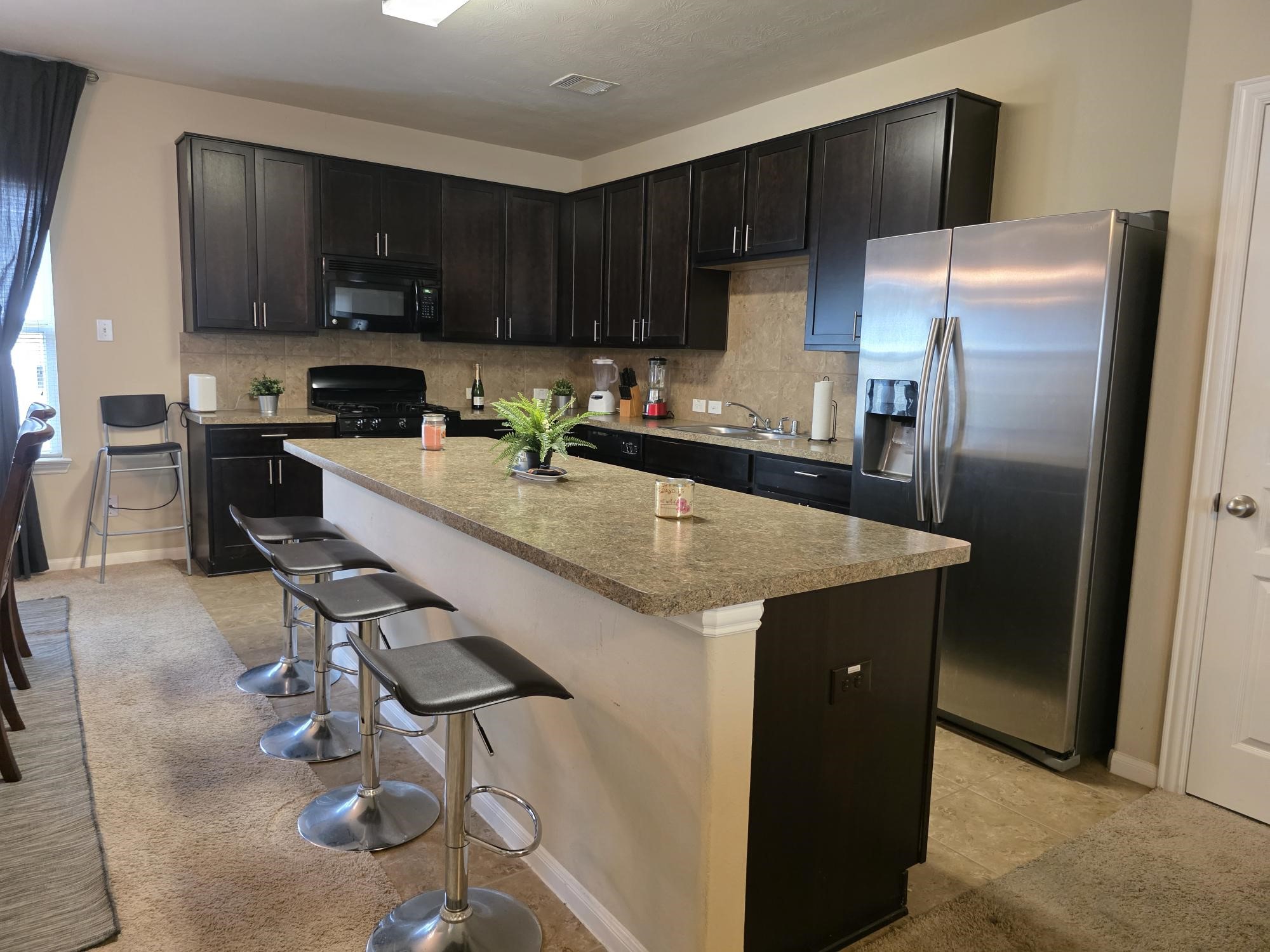 3219 Creole Bay Lane Rosenberg, TX 77471 - Photo 8 of 35 a kitchen with kitchen island granite countertop a sink stove and refrigerator
