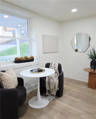 a living room with furniture window and wooden floor
