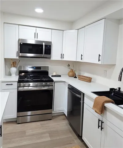 a kitchen with granite countertop a stove and a sink