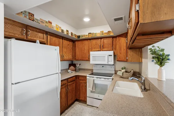 a kitchen with appliances a sink and cabinets