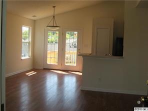 3040 Rockingham Court Southwest Concord, NC 28025 - Photo 2 of 14 a view of an empty room with wooden floor and a window
