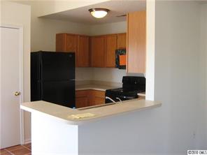 3040 Rockingham Court Southwest Concord, NC 28025 - Photo 4 of 14 a kitchen with a refrigerator and a stove