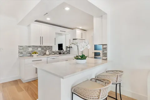 a kitchen with kitchen island a stove a sink and a refrigerator