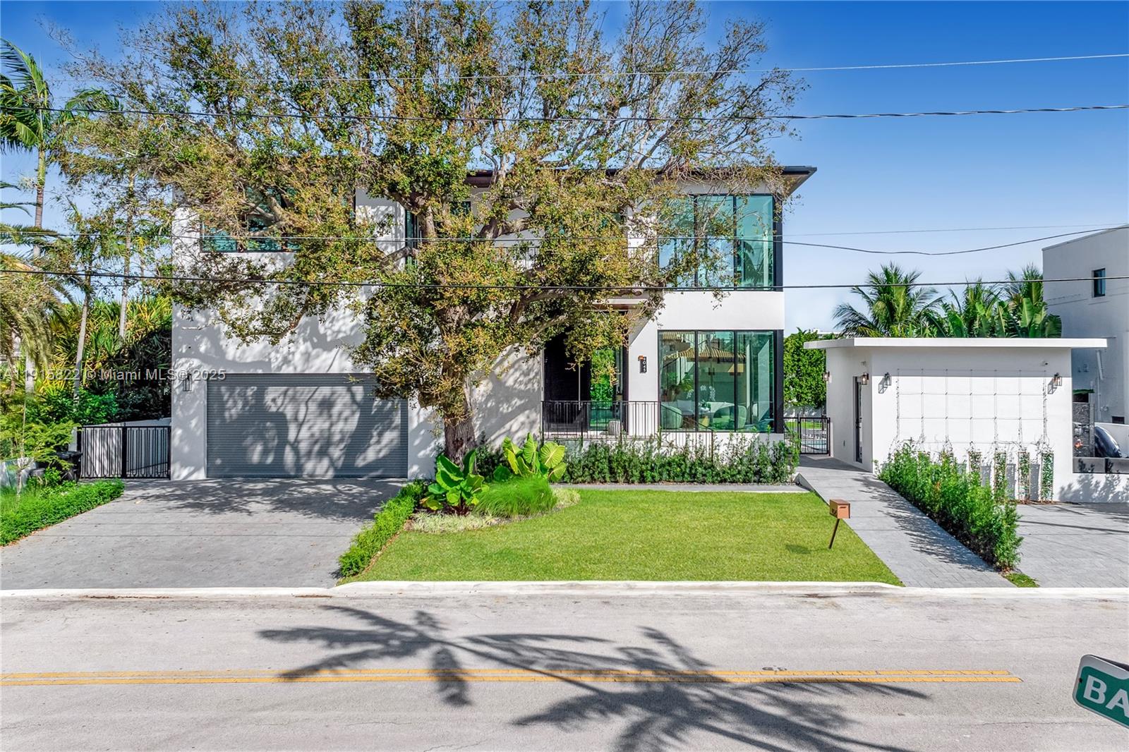 9045 Hawthorne Avenue Surfside, FL 33154 - Photo 13 of 61 a view of a house with a yard and a garden
