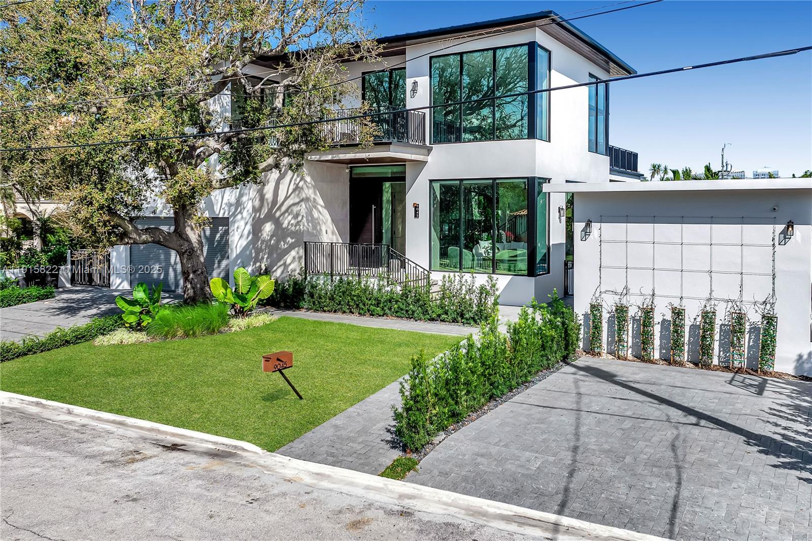 9045 Hawthorne Avenue Surfside, FL 33154 - Photo 14 of 61 a front view of a house with a yard and potted plants