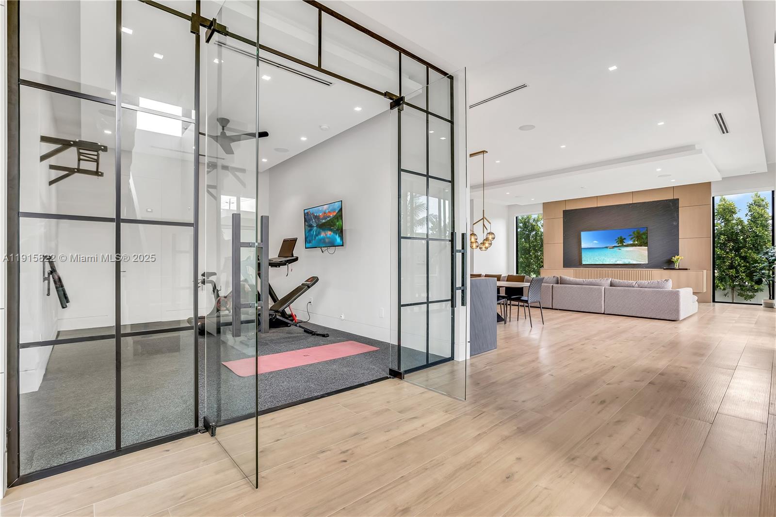 9045 Hawthorne Avenue Surfside, FL 33154 - Photo 19 of 61 a living room with a floor to ceiling window and a wooden floor