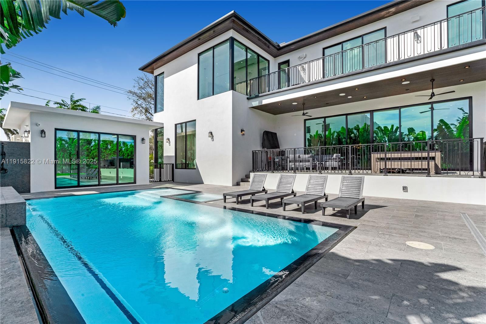 9045 Hawthorne Avenue Surfside, FL 33154 - Photo 2 of 61 a view of a house with pool and chairs in front of it