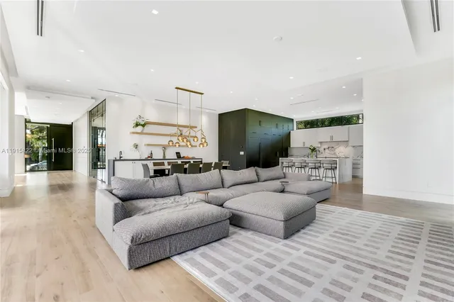 a living room with fireplace furniture and a large window