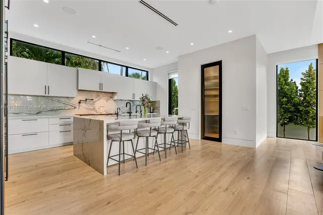 a dining room with furniture wooden floor and a chandelier