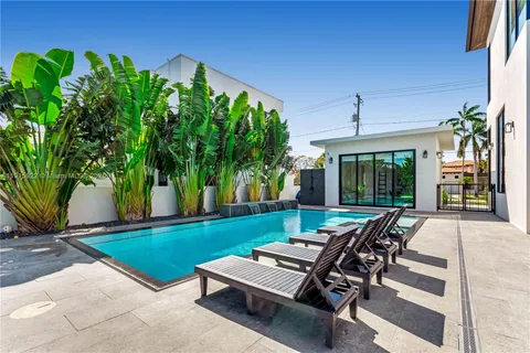 a view of a backyard with sitting area