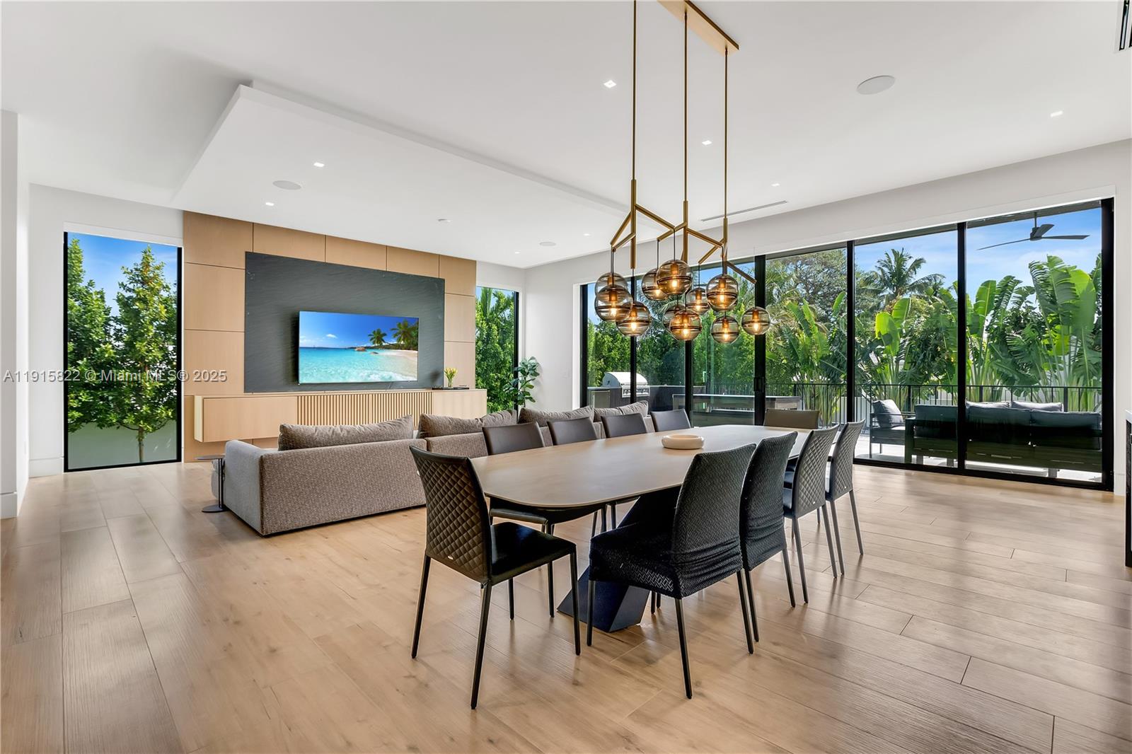 9045 Hawthorne Avenue Surfside, FL 33154 - Photo 31 of 61 a dining room with furniture wooden floor and a chandelier