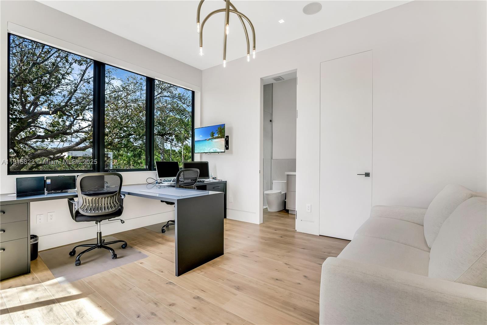 9045 Hawthorne Avenue Surfside, FL 33154 - Photo 40 of 61 a living room with furniture a rug potted plant and a large window