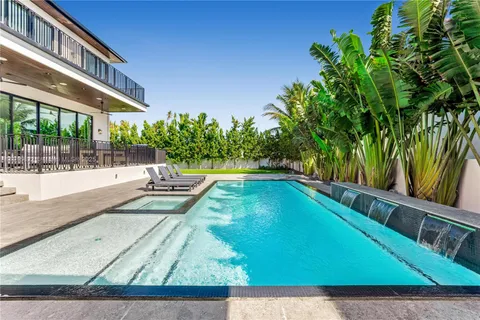a view of a backyard with plants and a patio