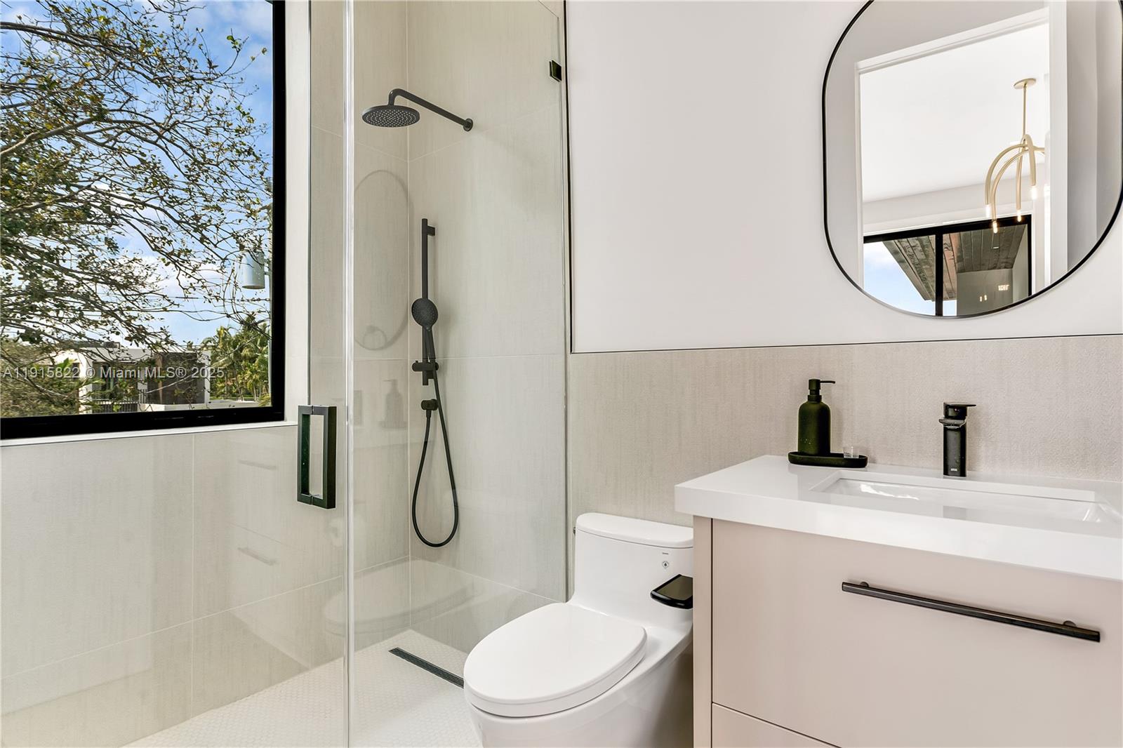 9045 Hawthorne Avenue Surfside, FL 33154 - Photo 41 of 61 a bathroom with a granite countertop sink mirror vanity and toilet