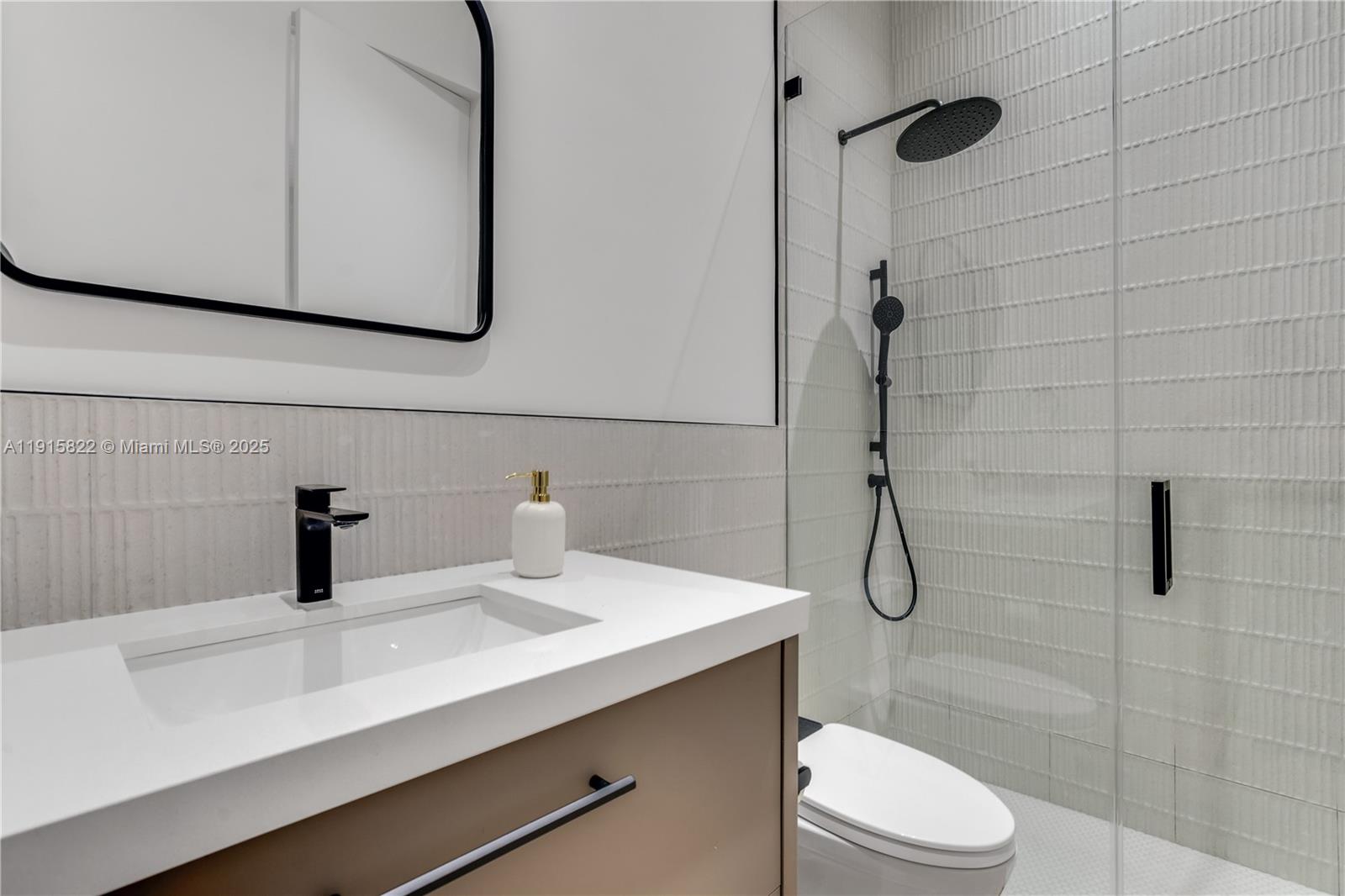 9045 Hawthorne Avenue Surfside, FL 33154 - Photo 45 of 61 a bathroom with a sink and mirror