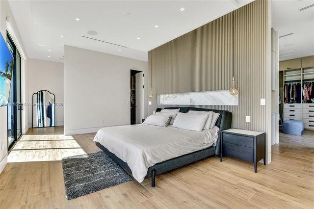 an aerial view of residential houses with outdoor space and lake view