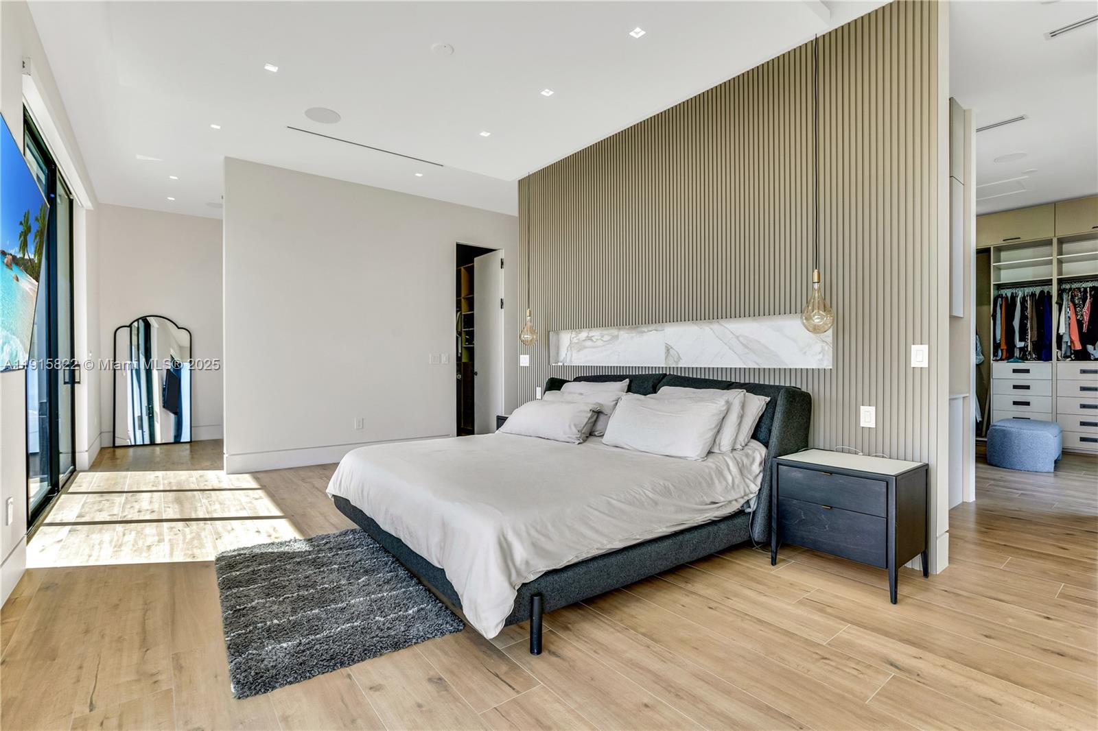 9045 Hawthorne Avenue Surfside, FL 33154 - Photo 47 of 61 a bedroom with a bed and a large mirror