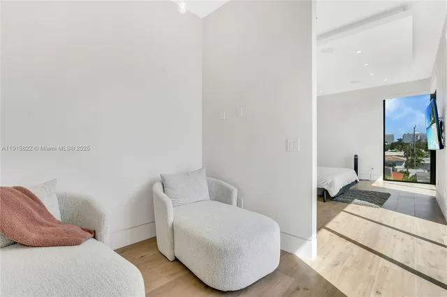 an aerial view of city and lake with trees all around