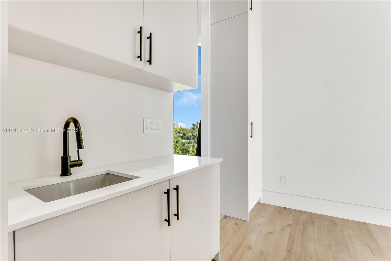 9045 Hawthorne Avenue Surfside, FL 33154 - Photo 49 of 61 a kitchen with a sink and a window