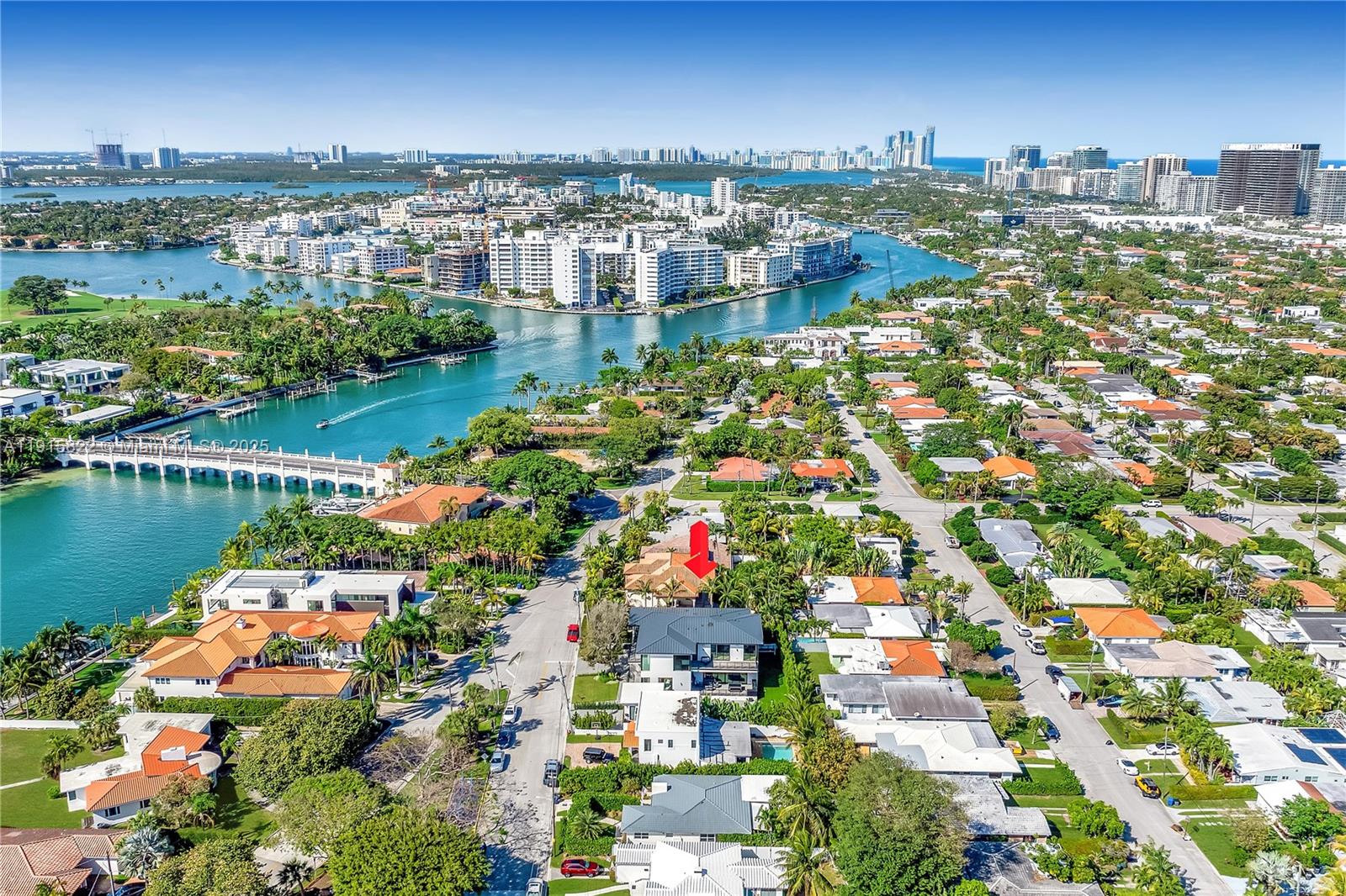 9045 Hawthorne Avenue Surfside, FL 33154 - Photo 58 of 61 an aerial view of city and lake with trees all around