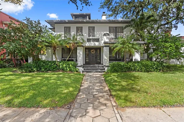 a front view of house with yard and green space