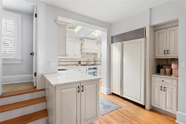a kitchen with white cabinets and appliances