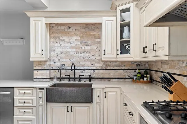 a kitchen with stainless steel appliances granite countertop a sink stove and cabinets