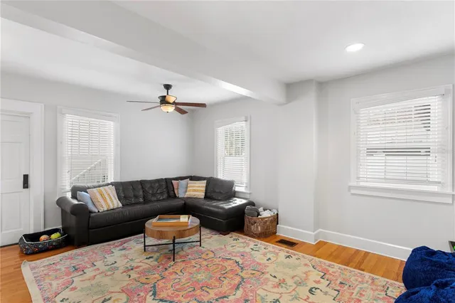 a living room with furniture and wooden floor