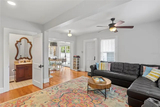 a living room with furniture a rug and a window