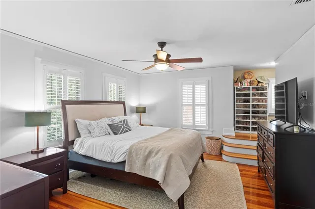 a bedroom with a bed and wooden floor