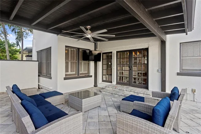a view of a house with wooden deck and furniture