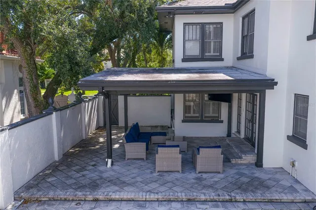 a living room with furniture a window and a chandelier