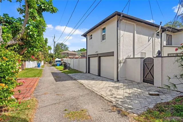 an aerial view of residential house with outdoor space and lake view in back