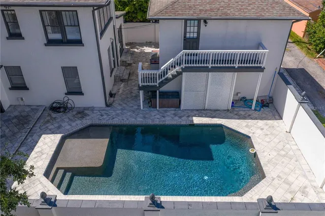 an aerial view of a city with lots of residential buildings ocean and mountain view in back