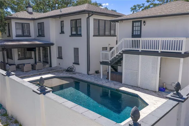 a view of a house with pool table and chairs