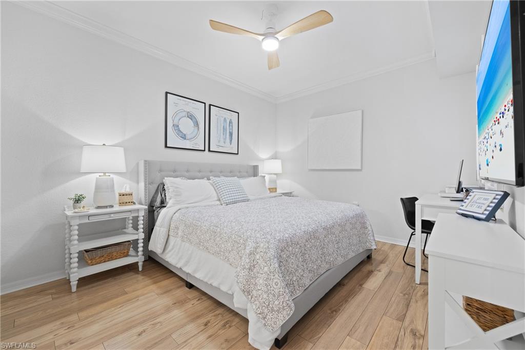 9715 Acqua Court, Unit 116 Naples, FL 34113 - Photo 11 of 43 a spacious bedroom with a bed and a table