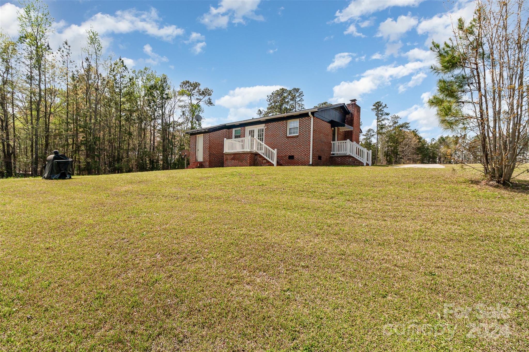 210 Wilson Road Union, SC 29379 - Photo 8 of 33 a house with yard and mountain in the background