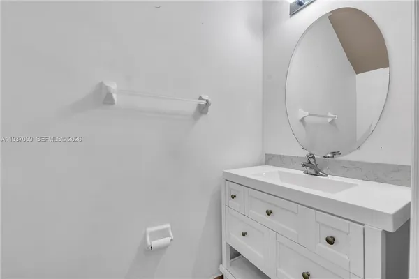 a view of a kitchen with a sink and a refrigerator