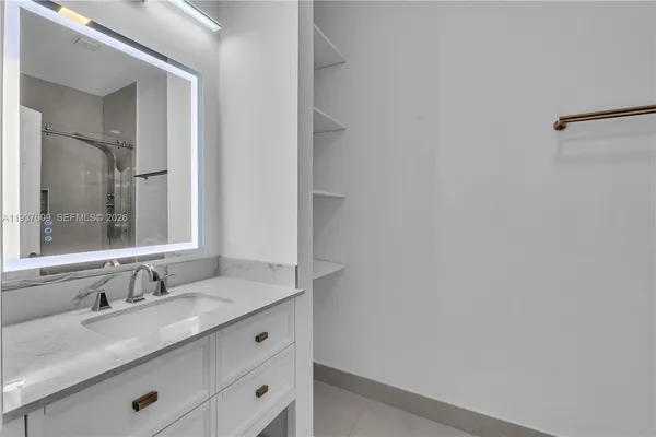 a view of a storage & utility room with a sink