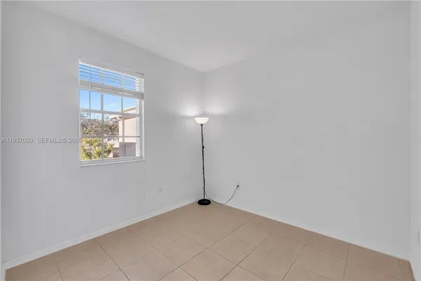 a view of a white house with a yard in front of it