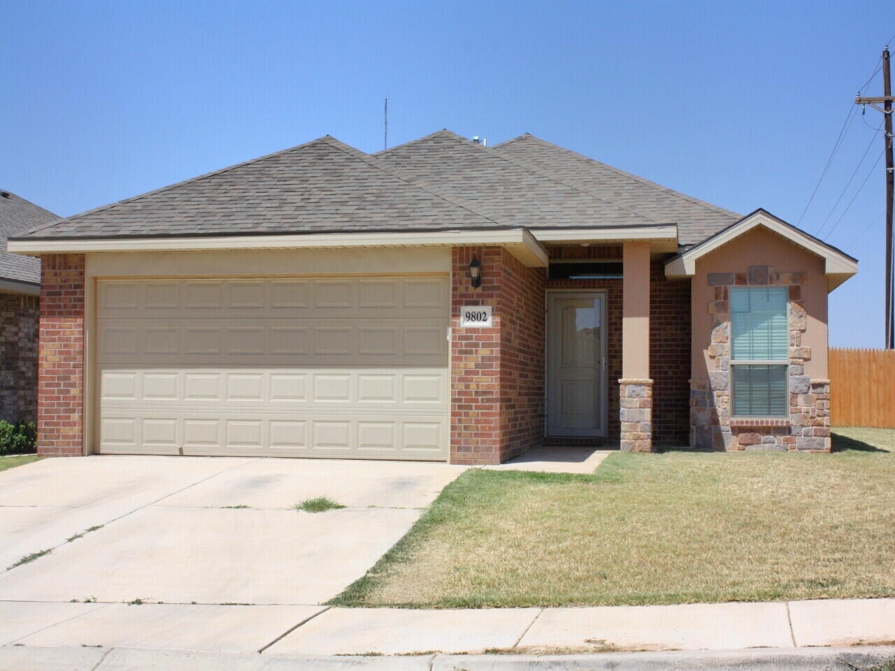 9802 Sherman Avenue Lubbock, TX 79423 - Photo 1 of 9 a view of a house with small yard plants and large tree