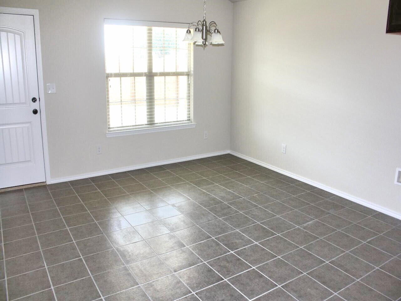 9802 Sherman Avenue Lubbock, TX 79423 - Photo 3 of 9 an empty room with a window