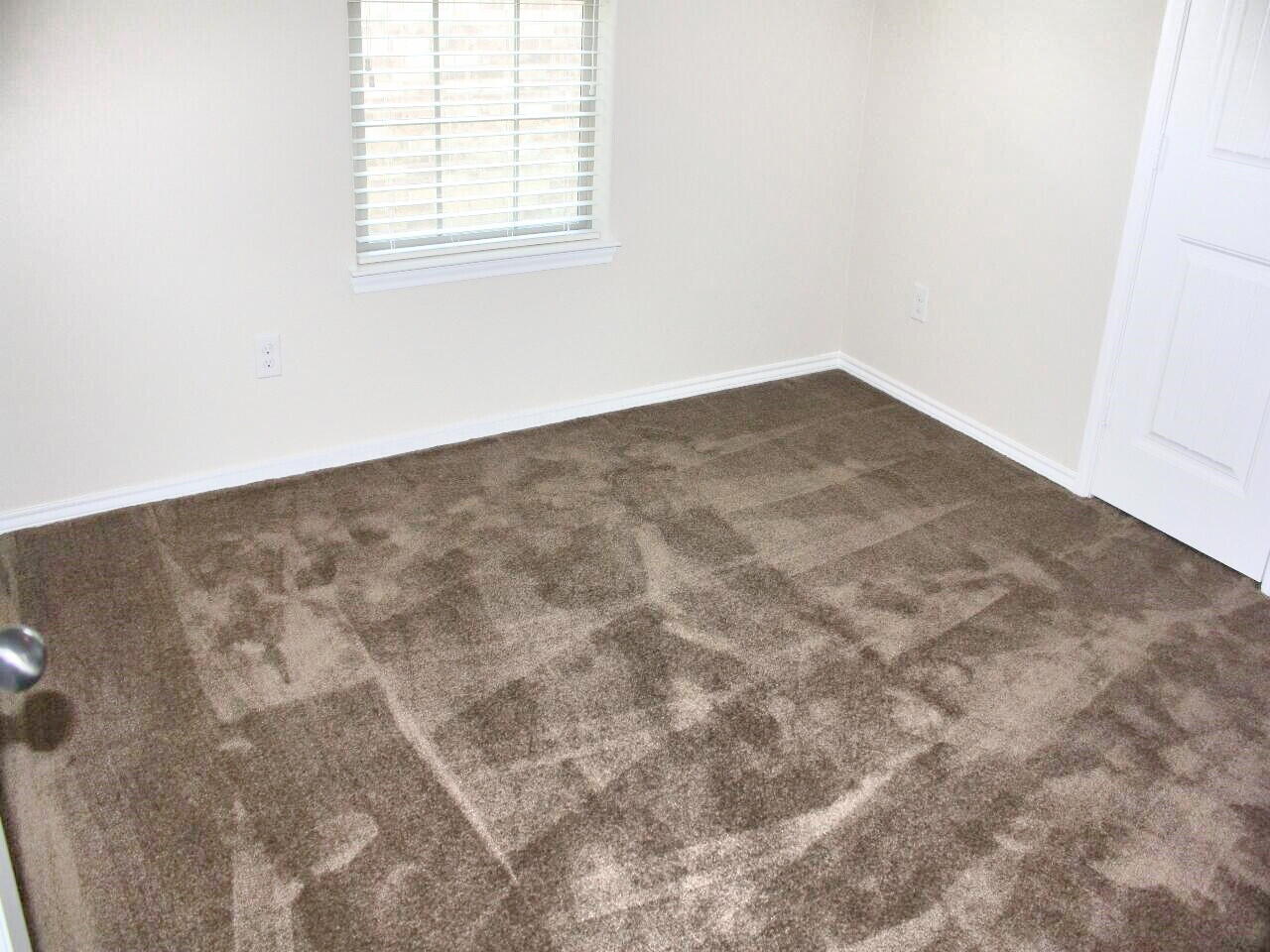 9802 Sherman Avenue Lubbock, TX 79423 - Photo 7 of 9 an empty room with a window